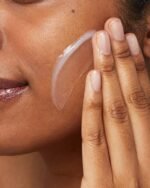 Woman applying Cerave Hydrating Facial Cleanser on her cheek
