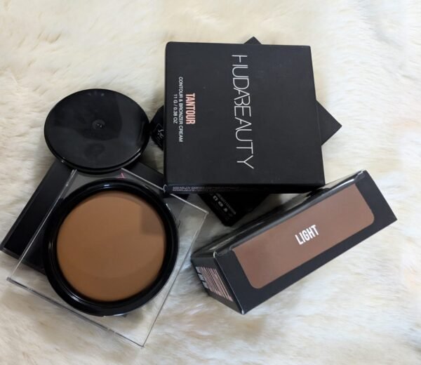 Huda Beauty Tantour Contour and Bronzer Cream in shade Light. A circular 11g compact showcasing the smooth, cool-toned brown cream formula for professional face sculpting and bronzing