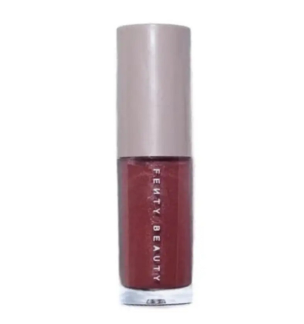 Fenty Beauty Gloss Bomb Universal Lip Luminizer mini 2ml bottle in the shimmering rose-mauve shade RiRi, featuring its signature hexagonal cap, available on glamit.pk Pakistan.