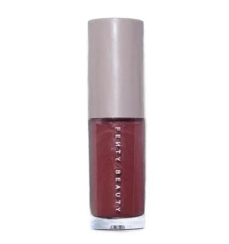 Fenty Beauty Gloss Bomb Universal Lip Luminizer mini 2ml bottle in the shimmering rose-mauve shade RiRi, featuring its signature hexagonal cap, available on glamit.pk Pakistan.