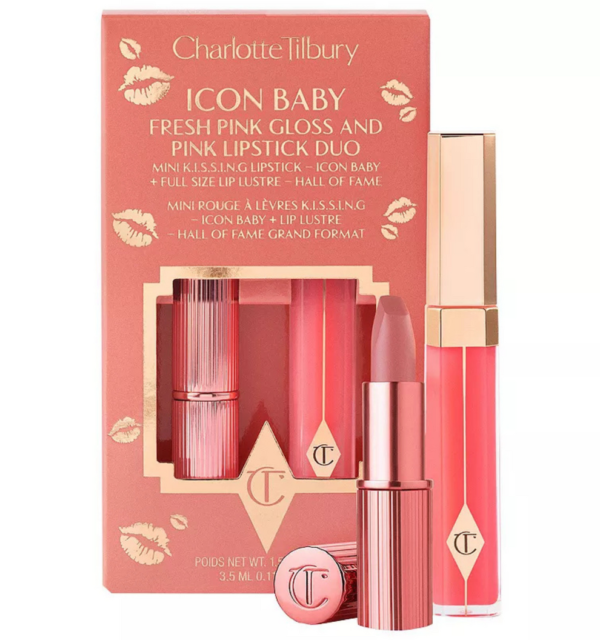 Charlotte Tilbury K.I.S.S.I.N.G satin lipstick bullet rolled up alongside its matching high-shine lip gloss wand on a luxury rose-gold surface, available on glamit.pk Pakistan.