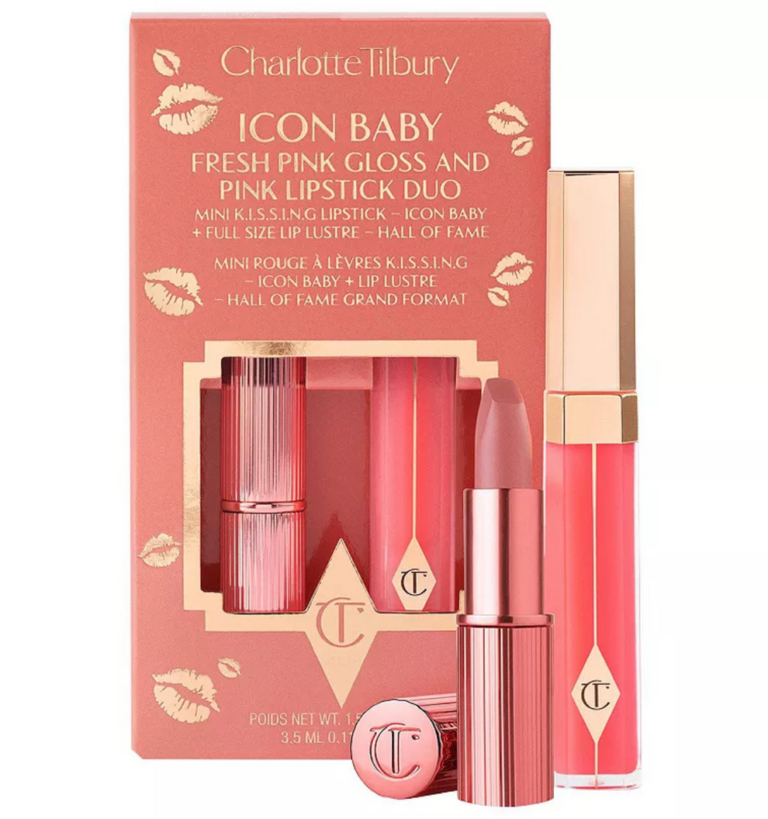 Charlotte Tilbury K.I.S.S.I.N.G satin lipstick bullet rolled up alongside its matching high-shine lip gloss wand on a luxury rose-gold surface, available on glamit.pk Pakistan.