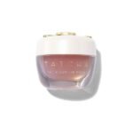 Premium frosted glass jar of Tatcha The Kissu Lip Mask showcasing its translucent peach-tinted jelly formula, complete with its signature gold applicator spatula, available on glamit.pk Pakistan.
