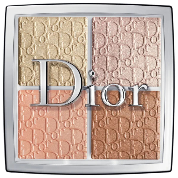 An open DIOR Backstage Glow Face Palette 002 showcasing four shimmery highlighter and blush shades embossed with the Dior logo on a mirrored surface with a makeup brush, available on GLAMIT PK.